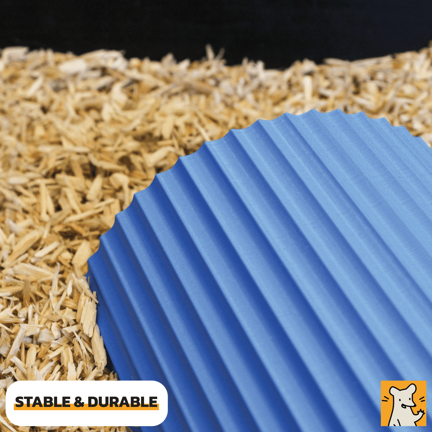 Dwarf hamster hideout in blue color on bedding, showcasing its stable and durable design for small pets.