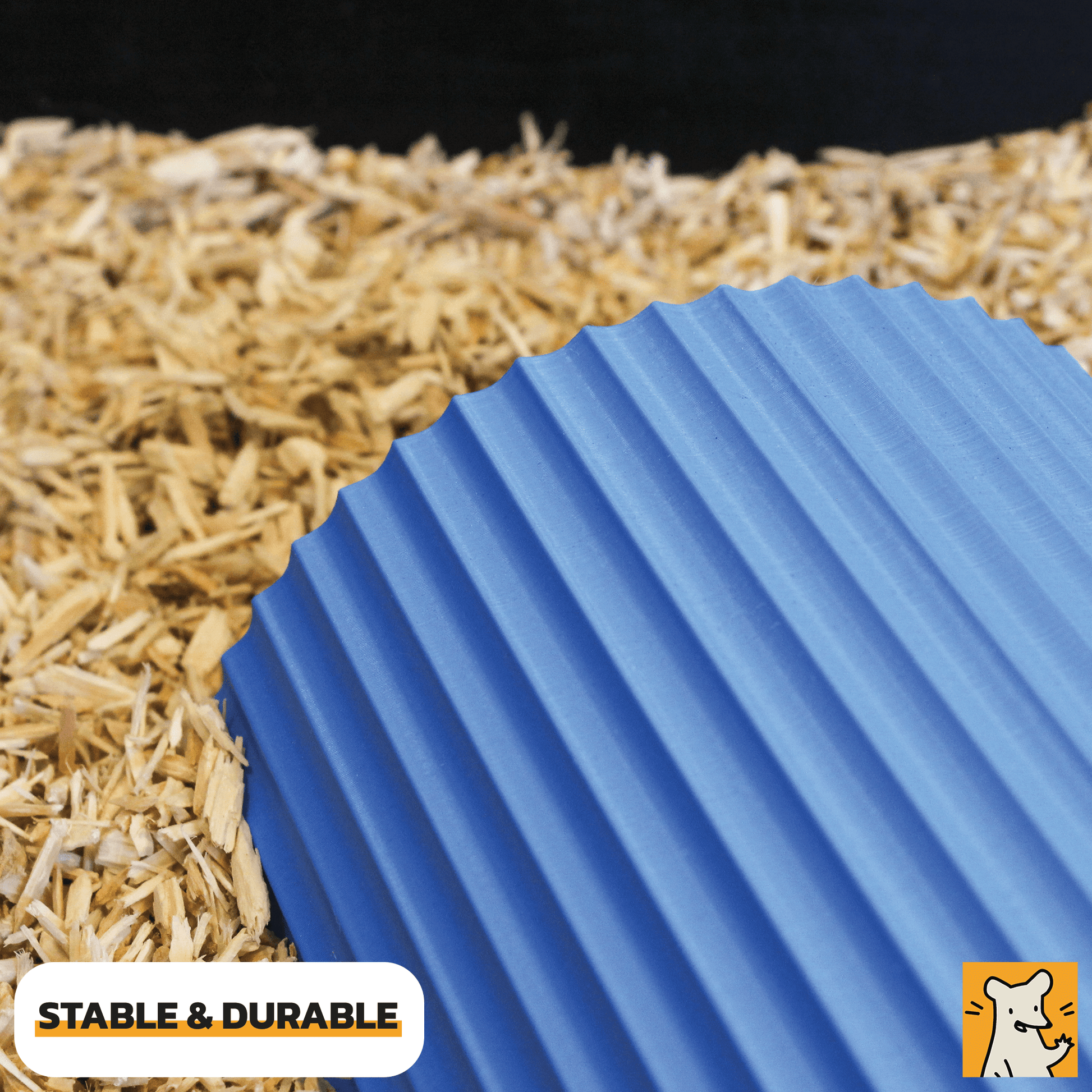 Dwarf hamster hideout in blue color on bedding, showcasing its stable and durable design for small pets.