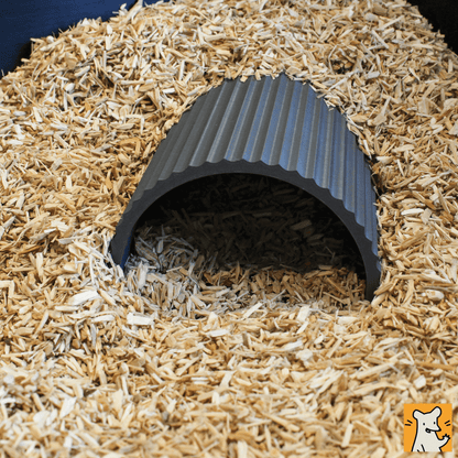 Dwarf hamster hideout nestled in bedding, providing a cozy refuge for small pets to relax and hide.